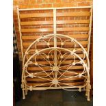 A cream metal double bed frame.