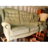 A green two seater sofa and matching armchair. (2)