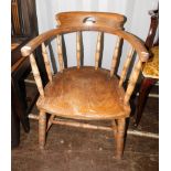 A late 19thC ash and elm captains chair, with turned supports and solid seat.