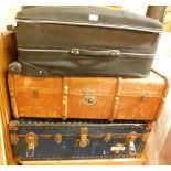 Trunks and cases, comprising a modern black material case, a tan bound trunk, and a blue canvas line