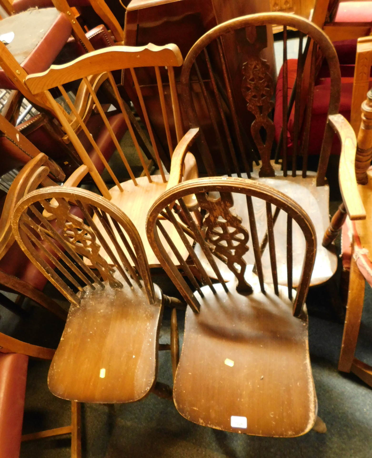 A group of chairs, comprising a wheel back kitchen chairs, two wheel back chairs, and a pine rocking