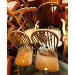 A group of chairs, comprising a wheel back kitchen chairs, two wheel back chairs, and a pine rocking