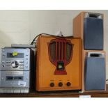 A radio and cassette player and a traditional type CD FM/AM radio with speakers. (4)