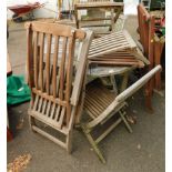 A wooden circular garden table, and various garden chairs. (AF)