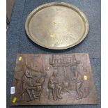 An Eastern hammered brass tray and a brass plaque.