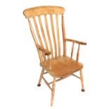 A stained beech lath back grandfather chair, with shaped arms, 122cm high, 62cm wide.