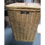 A lidded wicker linen basket.