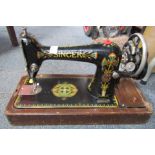 A Singer manual sewing machine in oak case.