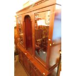 A mahogany display cabinet, with moulded cornice top, open shelf centre and two cupboards on a sideb