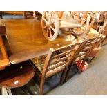 A dark oak dining table and four associated chairs. (5) The upholstery in this lot does not comply w