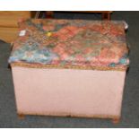 A pink Lloyd Loom linen basket, with cushioned seat.