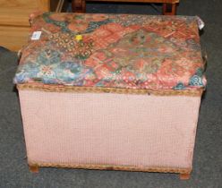 A pink Lloyd Loom linen basket, with cushioned seat.