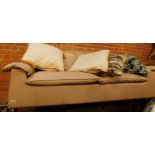 A beige leather finish three seater settee.