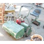 A vintage petrol Atco mower, roller with seat attachment and roller. (a quantity)