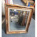 A gilt framed rectangular wall mirror.