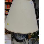 A blue and white pottery table lamp, with large cream shade. WARNING! This lot contains untested