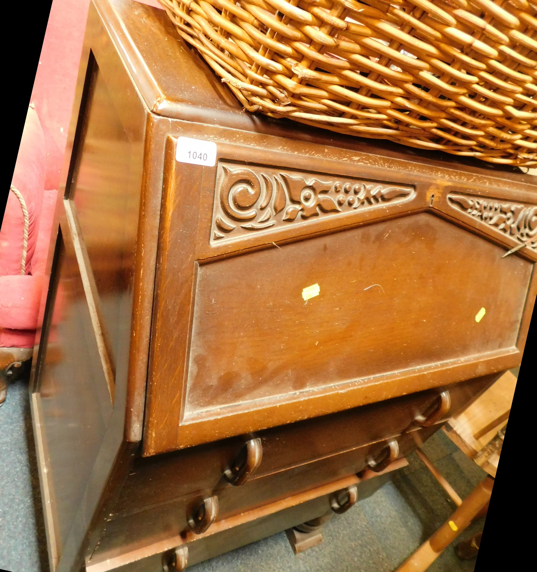 A carved oak bureau.