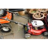 A Cobra DG350V petrol lawnmower.