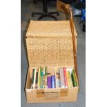 A wicker laundry basket, walking stick, and group of books on steam and steam engines.
