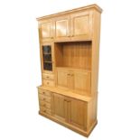 A craftsman made elm side cabinet, the top with an arrangement of panelled doors, a leaded glass doo