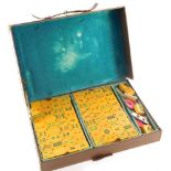 A Mahjong set, in leather case with resin pieces, the case 28cm wide.