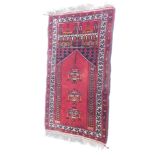 An Eastern prayer rug, decorated with a Mihrab, medallions, geometric motifs, etc., 114cm x 71cm.