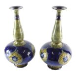 A pair of early 20thC Royal Doulton Art Nouveau vases, decorated in blue and green glazes, with styl