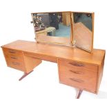 An Austin Suite teak dressing table, with triple mirror and six drawers, on end supports, 170cm wide