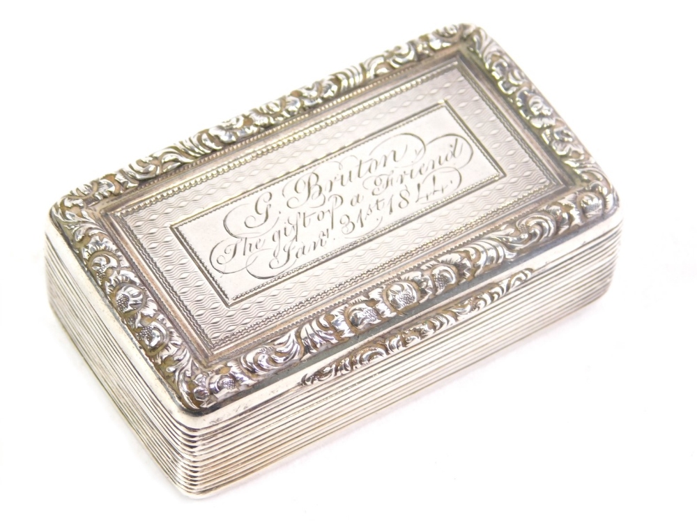 A Victorian silver snuff box, with chased decoration, scroll border and plain silver gilt interior,