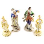 A pair of 20thC Sitzendorf figures of a lady and gentleman, each dressed in finery polychrome decora
