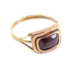 A Victorian dress ring, with red stone and part pierced shank, size N, unmarked, in an associated Ti