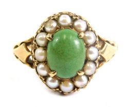 A 9ct gold dress ring, claw set with central green stone surrounded by pearls, size N, 1.8g.