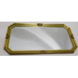 A 20thC bevel glass mirror, in oval frame, with shell and scroll moulding, 82cm x 132cm.