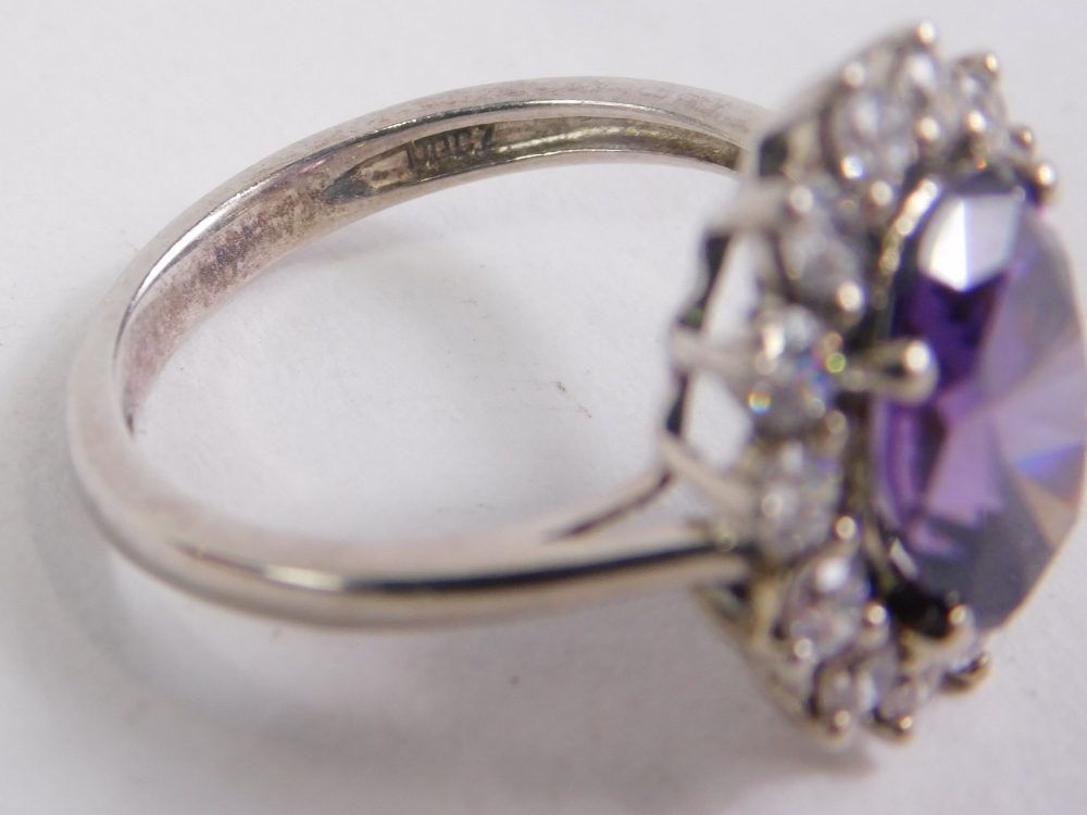A dress ring, claw set with central purple stone, with floral surround of small diamonds on a part p - Image 2 of 3