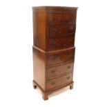 A bow fronted walnut chest on chest, the chest with a moulded cornice above three long drawers, the