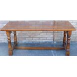 A Titchmarsh and Goodwin oak refectory table, the rectangular top on turned supports with H stretche