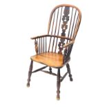 A 19thC ash and elm Windsor armchair, with a pierced splat, solid seat on turned legs with H stretch