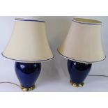 A pair of blue glazed and glass ceramic table lamps with shades, 71cm high.