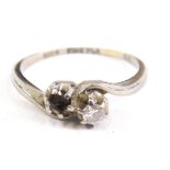 A crossover ring, set with one small claw set stone, (one lacking), white metal marked 18ct, 7g all