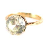 A moissanite dress ring, round brilliant cut, set in unmarked yellow metal, 9.4mm x 5.4mm, ring size