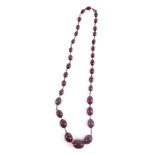 A faux amber necklace, set with graduated cherry coloured beads on a plain string, 70cm long.