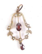 An Edwardian 9ct gold drop pendant, set with pearls and claw set with a central garnet, with further