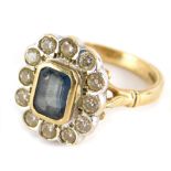 A 9ct gold dress ring, with baguette cut central green stone surrounded by small white stones, on a