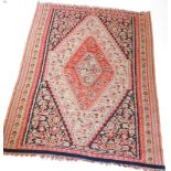 A Kilim rug, with a large central lozenge shaped medallion, in orange, red, gold, black and beige, w