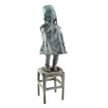 Early 20thC School, figure of a girl standing on stool, with hand to mouth, bronze, 30cm high.