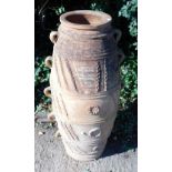 A continental terracotta garden vase, with ten handles, decorated with ovals and geometric devices,