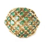 A 9ct gold filigree dress ring, claw set with small green stones in a basket setting, size M, 5.7g a