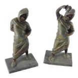 A pair of early 20thC bronze figures, each in flowing robes once holding cups, one with etched numbe
