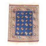 A small Persian rug or mat, with a star design, on a blue ground with multiple borders, 75cm x 59cm.