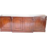 A mahogany sideboard in Victorian style, the top with a moulded edge above four drawers each with ar